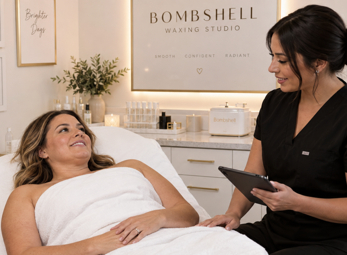 Woman receiving a waxing consultation in a clean treatment room, highlighting post-wax skincare for changing skin during GLP-1 weight loss.